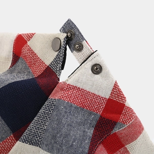 Macro shot of British style plaid fabric texture with vintage metal snap buttons