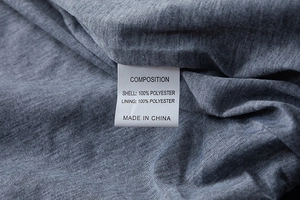 Macro detail of breathable polyester fabric texture and care label for men's casual jacket