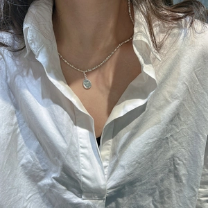 Minimalist S925 sterling silver smile pendant necklace worn on a model with white shirt