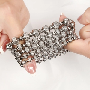 Sparkling silver stainless steel elastic beaded bracelet with layered textured metal beads