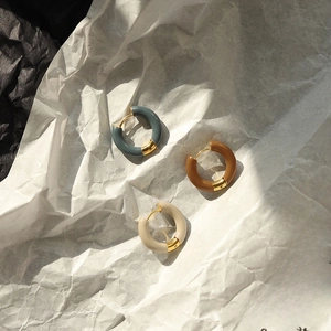 Detail of gray, caramel, and beige resin hoop earrings with 18K gold-plated steel base