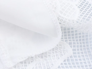 Detail view showing white puff sleeve mesh fabric and fine lace stitching on the dress