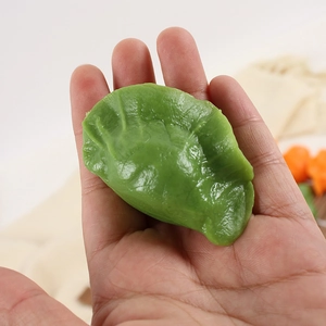 Realistic green dumpling model with authentic pleat texture and glossy simulation finish