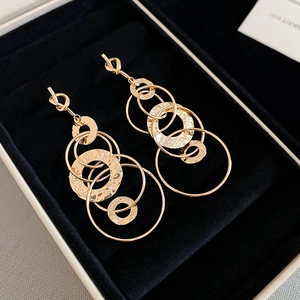 Close-up of golden multi-hoop earrings with hammered texture in black jewelry box