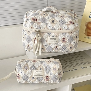 Quilted teddy bear makeup bag set with blue bows and spacious storage compartments