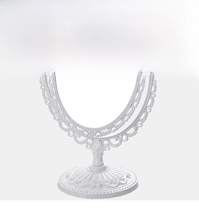 Detail of vintage white desktop mirror with floral relief patterns and PP frame