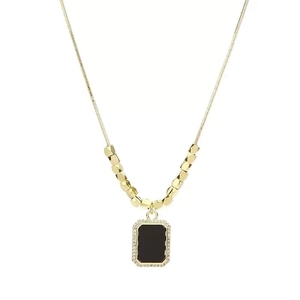 Elegant gold necklace with a black rectangular pendant surrounded by sparkling rhinestones