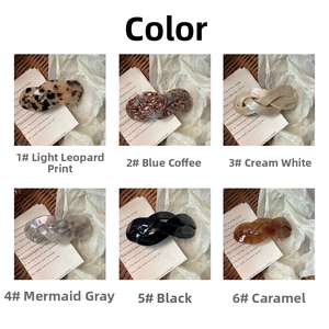 Detail view of large acetate twist spring hair clips in six vintage marble colors