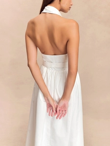 Détail de la robe blanche élégante avec dos nu et texture plissée sophistiquée