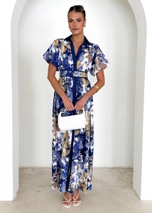 Detail of floral print maxi dress with ruffle collar and puff sleeves for holiday vacation