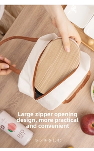 Dettaglio macro della borsa termica in tela con cerniera e bento box con coperchio in legno