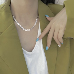 Modern S925 sterling silver pig nose choker necklace worn with a green blazer outfit
