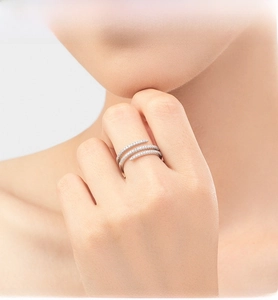 Detail of s925 silver triple-layer spiral ring with micro-pave crystals on a model finger