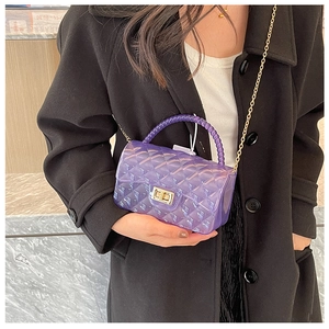 Detail of purple jelly bag with quilted texture, gold chain and beaded handle