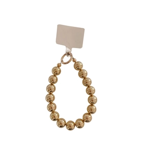 Chic gold-plated acrylic beaded wrist lanyard with a spring clasp on a white background