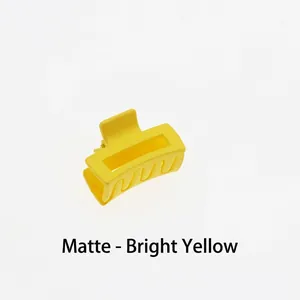 Detail shot of a 4cm mini matte bright yellow hollow square hair claw clip in a simple style