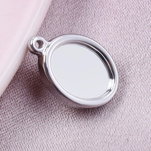 Macro shot of silver oval stainless steel pendant tray on lavender fabric background