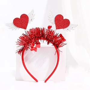 Detail of red Valentine's Day headband with glittery winged hearts and sequin accents
