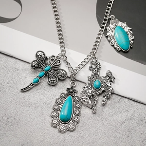Retro silver necklace with turquoise dragonfly and horse pendants on textured background