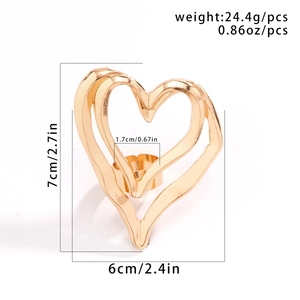 Golden heart-shaped metal decorative ring stand with intricate engraved patterns