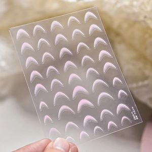 Macro view of ultra-thin pink gradient French manicure nail stickers on clear sheet