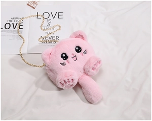 Detailed close-up of pink plush kitten crossbody bag with golden chain and embroidery