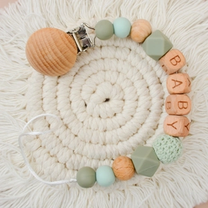 Close-up of beech wood pacifier clip with BABY letter beads and silicone crochet beads