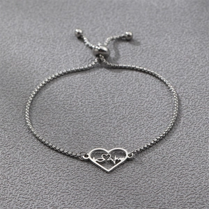 Macro detail of silver stainless steel heartbeat bracelet with adjustable drawstring