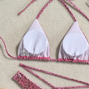 Detail of pink leopard bikini lining with size S washing label and soft chest pads