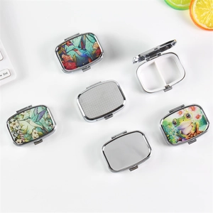 Portable 2-compartment metal pill box with hummingbird and frog floral patterns