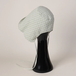 Detail of green and white gingham baby sun hat with protective ear flaps and chin ties