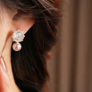 Elegant silver earrings with square zircon flower and dangling pinkish-purple pearls