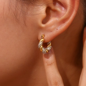 Close-up of 18K gold plated twisted rope hoop earrings with pavé set crystals on model