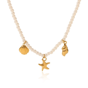 Detailed macro view of white faux pearl necklace with gold shell and starfish pendants