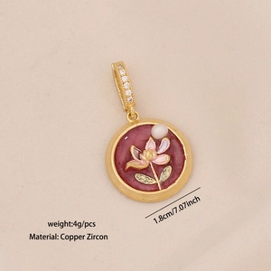Macro detail of French vintage enamel flower pendant with pearl and copper zircon specs