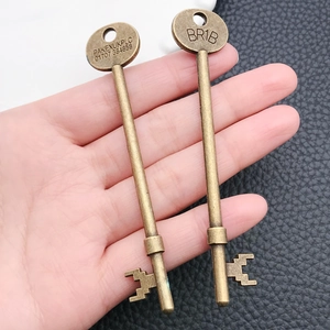 Close-up of two vintage brass alloy skeleton keys featuring engraved serial numbers