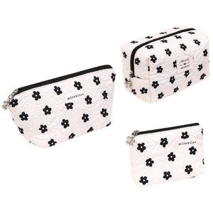 Cute white quilted cosmetic bag set with black floral patterns and silver zipper pulls