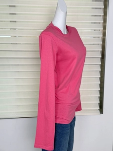 Side view of rose pink long sleeve t-shirt with front pocket on mannequin