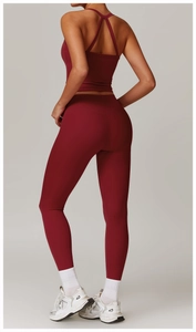Detail view of burgundy yoga top and high-waisted leggings with cross-back design