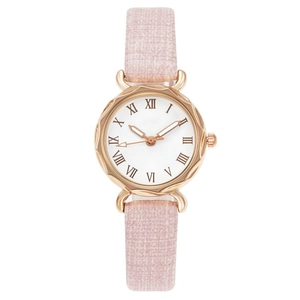 Detail of rose gold watch case with Roman numeral dial and pink textured strap