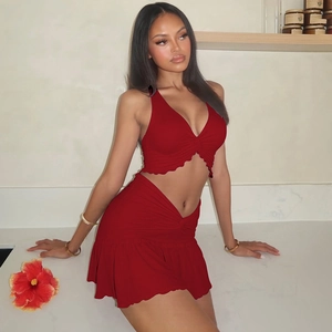 Detail of red two-piece set featuring V-neck halter crop top and ruched mini skirt