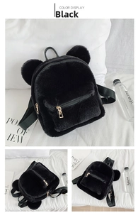 Detail of black plush bear backpack showing soft faux fur and golden metal zippers