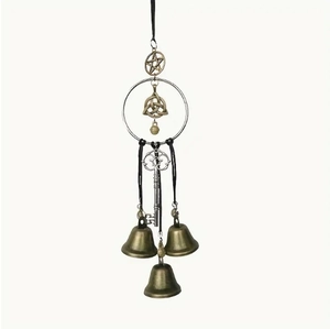 Detailed close-up of bronze and silver witch bells with Celtic knots and star charms