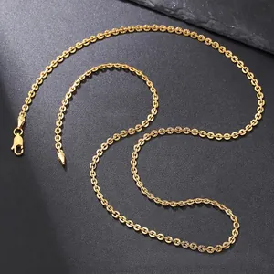 Detailed close-up of golden textured link chain with secure lobster clasp on grey surface