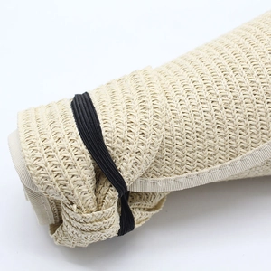 Detailed macro of foldable beige straw hat texture with elastic band for storage
