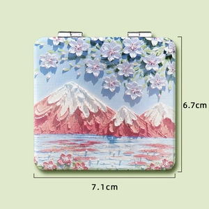 Detailed relief painting of Mount Fuji and cherry blossoms on a compact makeup mirror