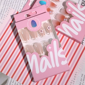 Sparkling pink press-on nails with 3D floral accents in short ballet shape packaging