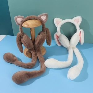 Detail view of brown and white plush cat ear muffs with moving ears and sequins