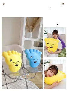 Detail of plush giant foot pillows in yellow and blue colors with cartoon smiling faces