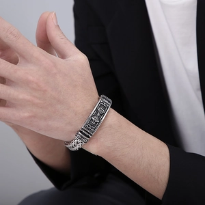 Detailed view of men's vintage titanium steel bracelet with engraved totem plaque